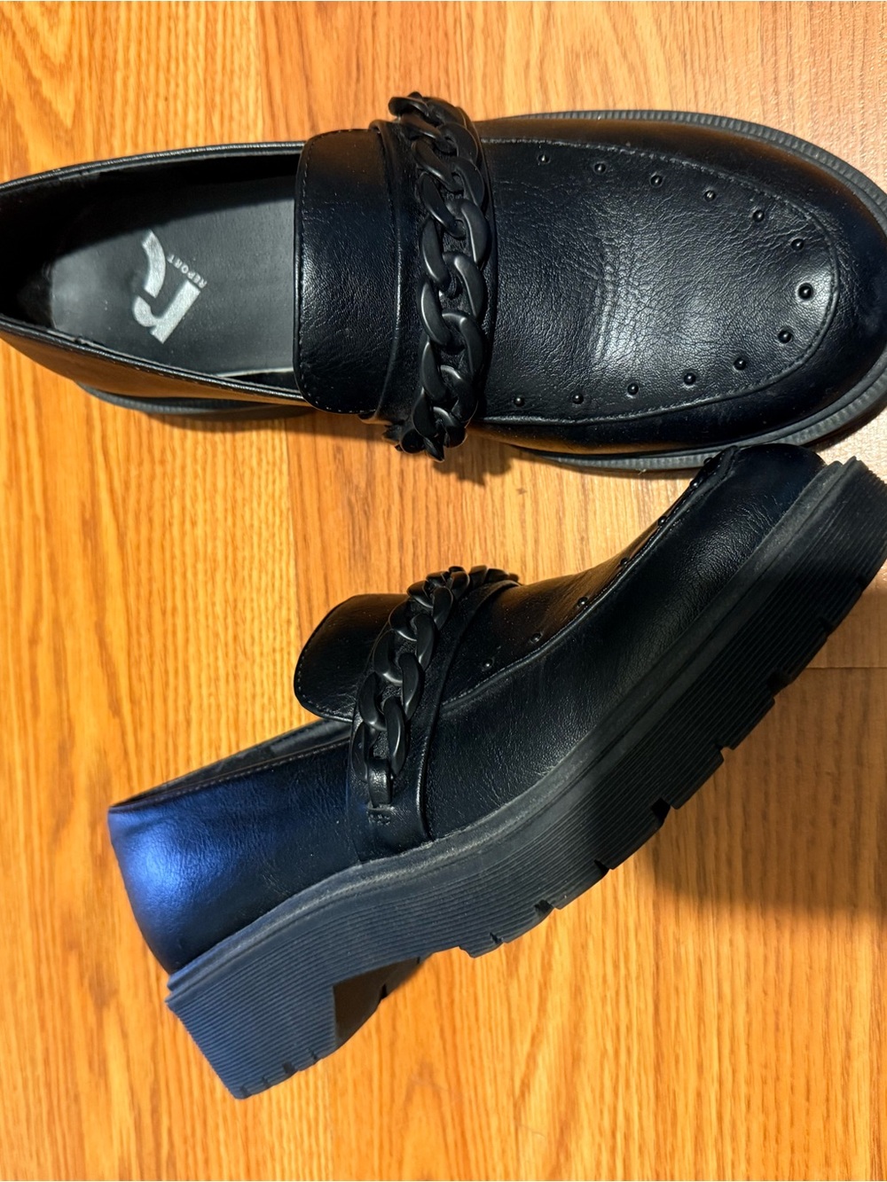 Black loafers with chain detailing